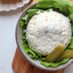 Egg and pickle chicken salad on a bed of lettuce.