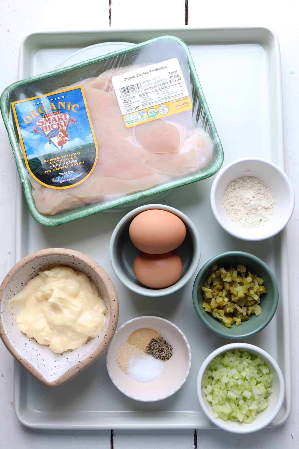 Ingredients for chicken salad on a tray.
