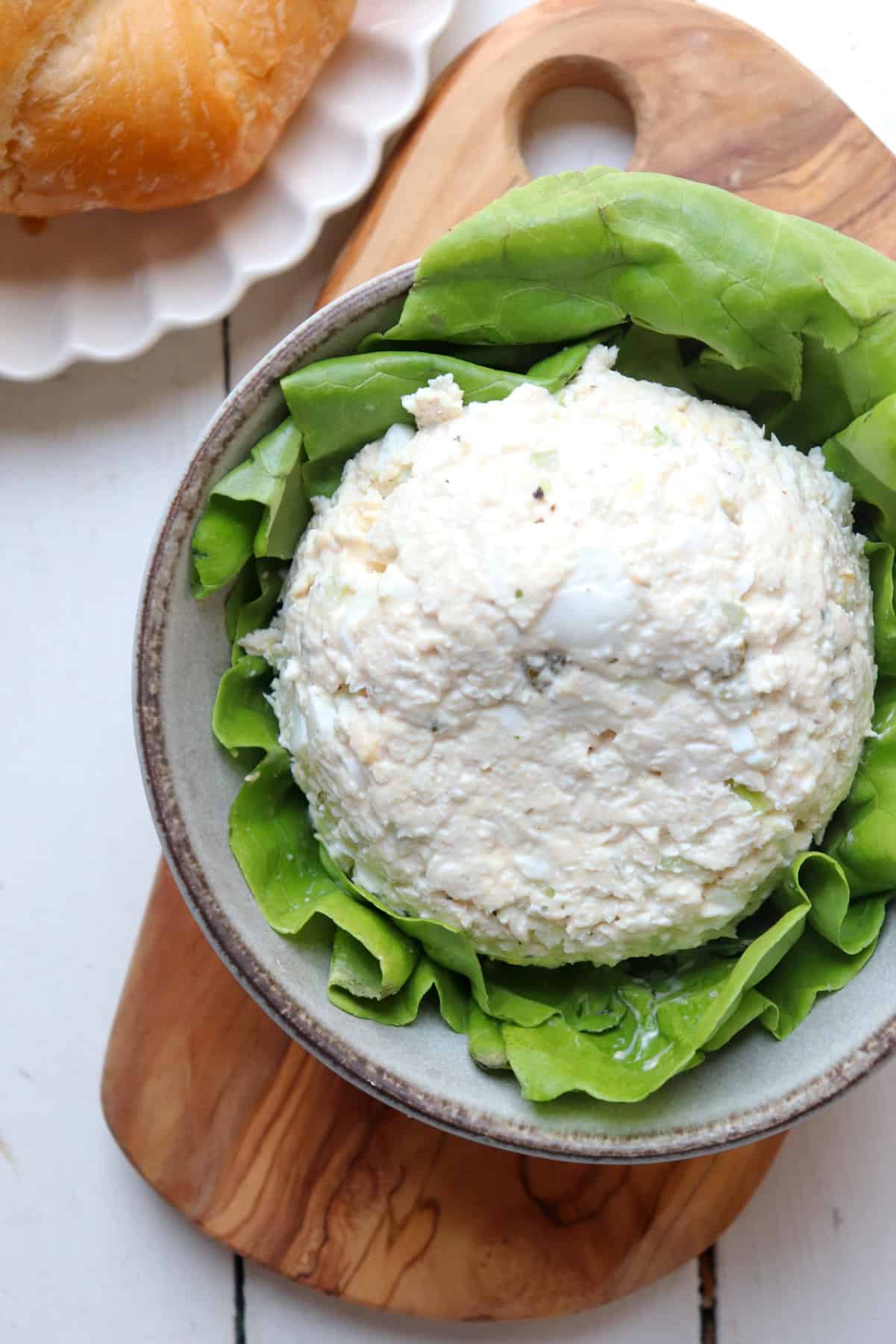 Chicken salad in bowl with lettuce.