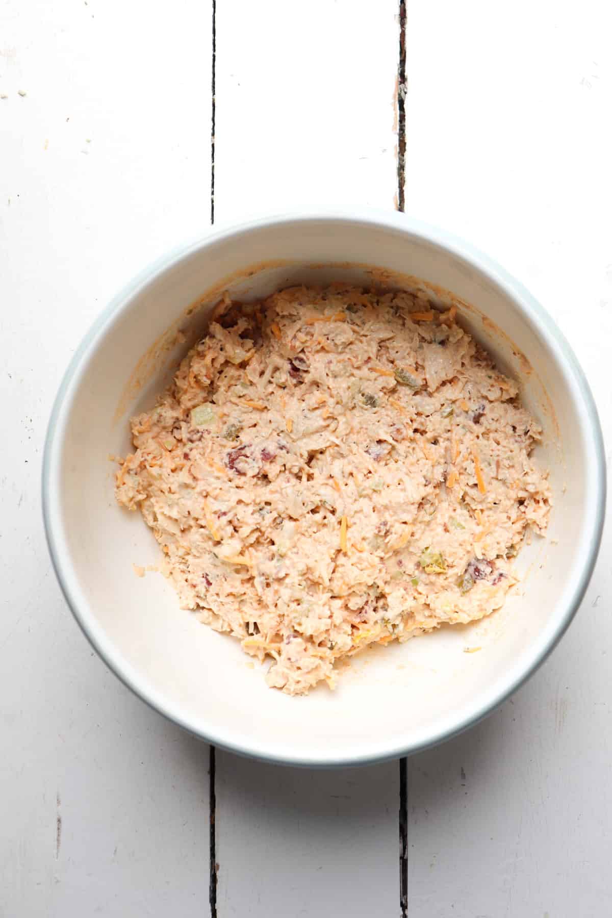 mixed chicken salad in a white bowl.