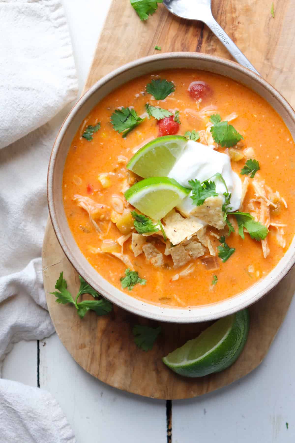 bowl of creamy chicken enchilada soup with garnishes.