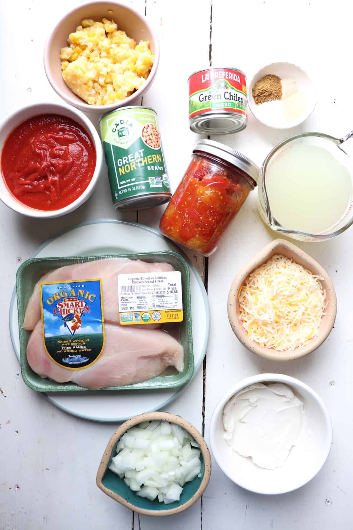 ingredients for chicken enchilada soup on a white table.