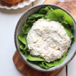 scoop of chicken salad on a bed of lettuce in a bowl.