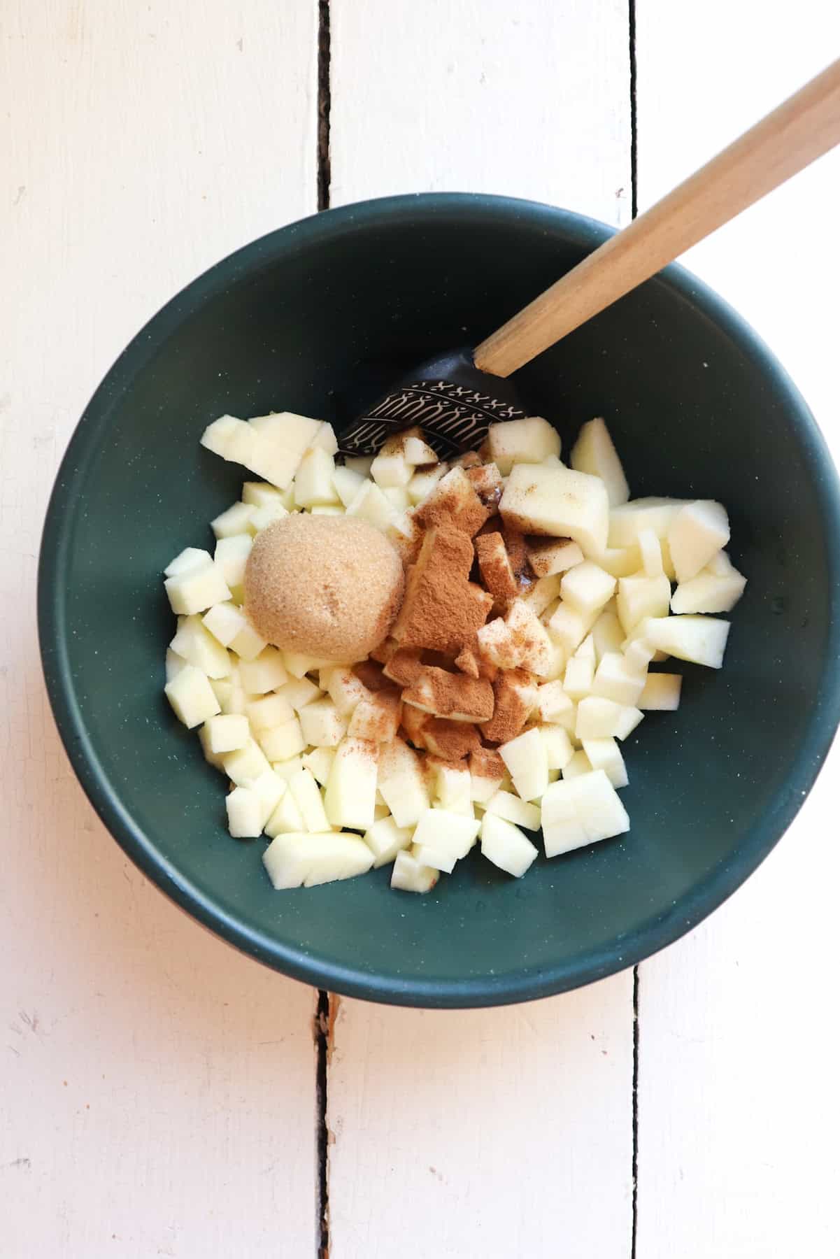diced apples in bowl with spices.