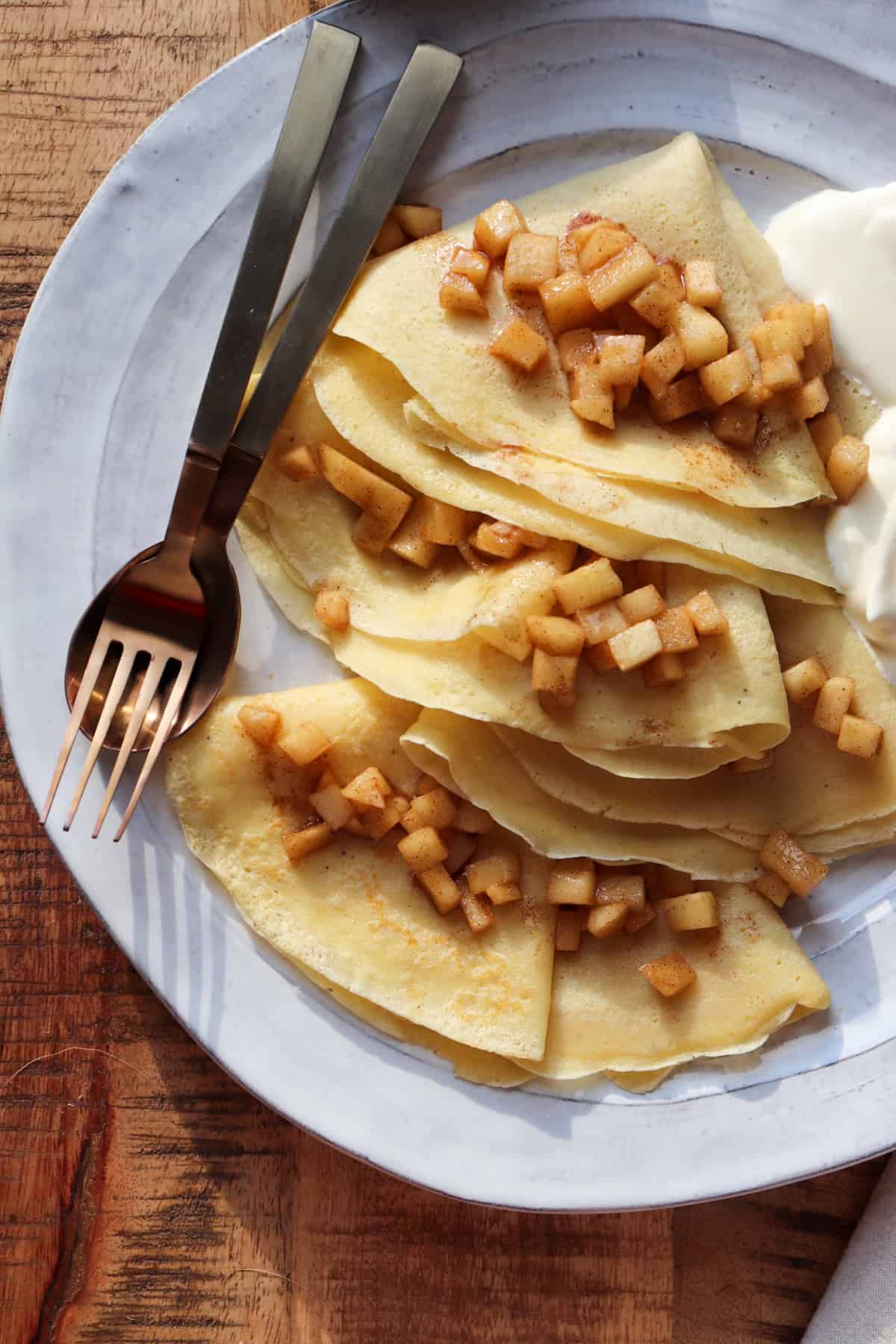 apple cinnamon crepe with utensils. 