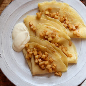 cinnamon apples on crepes with whipped cream.