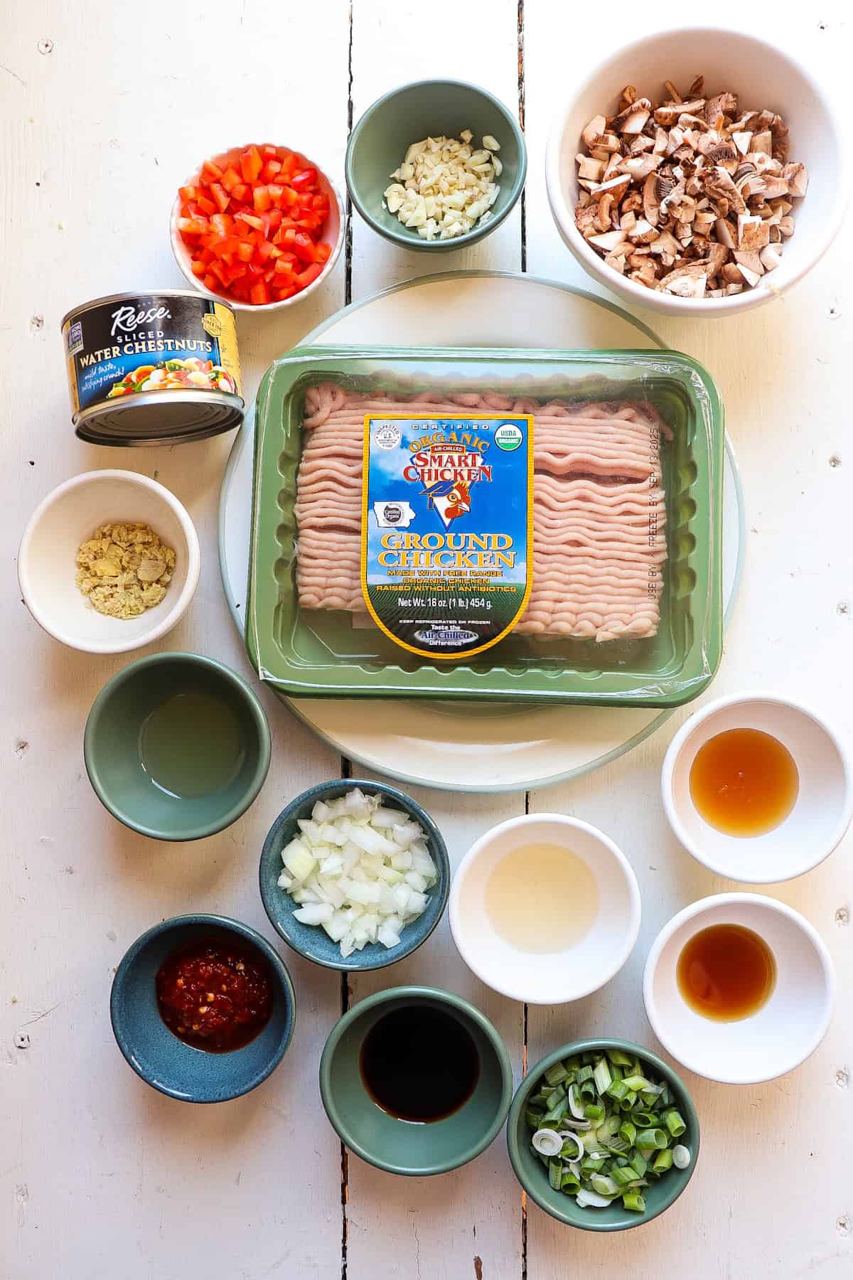 ingredients for asian chicken lettuce wraps on a shite background.