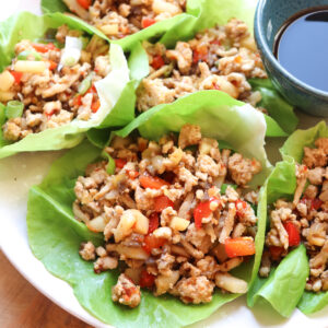 featured image of asian chicken lettuce wraps on a plate.