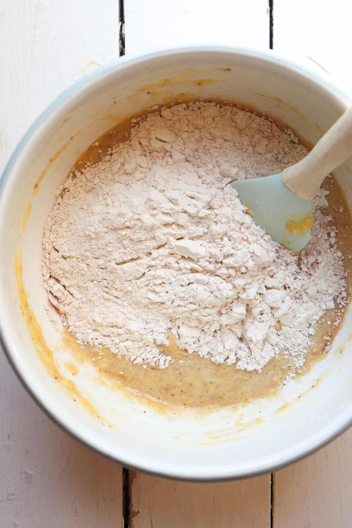 dry ingredients folded into wet ingredients for banana nut bread mini muffins.