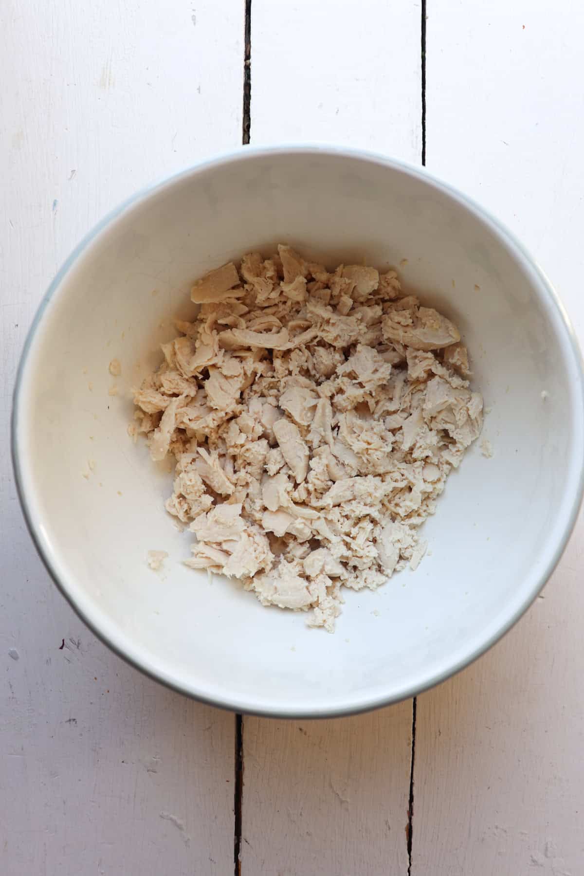 shredded chicken tenderloins in a bowl.