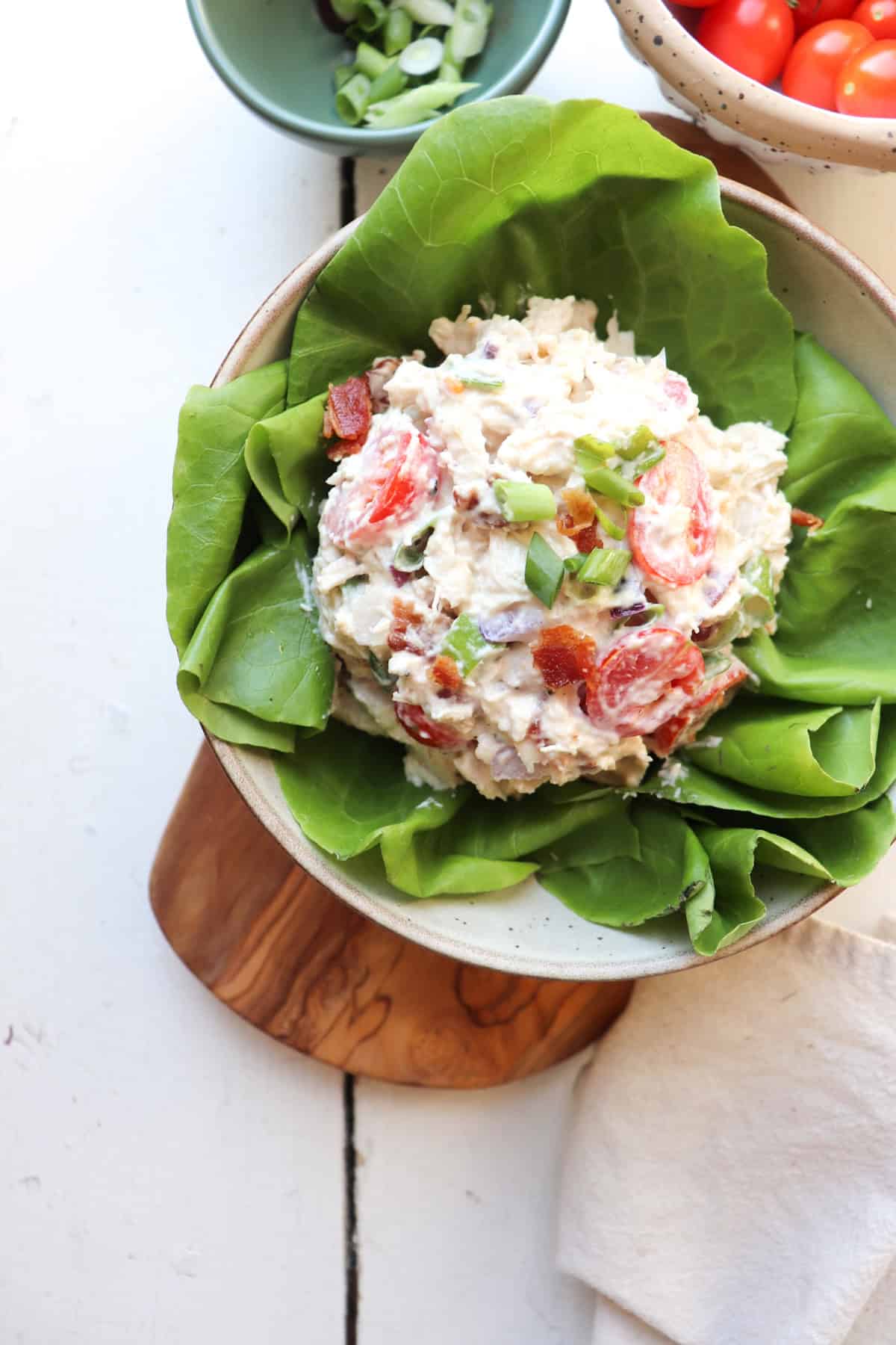 blt chicken salad on a bed of lettuce in a bowl.