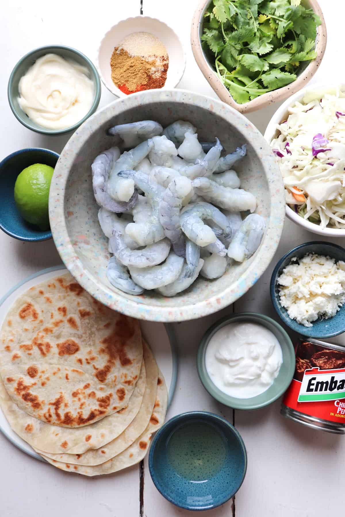 finished baja shrimp tacos on a white table.