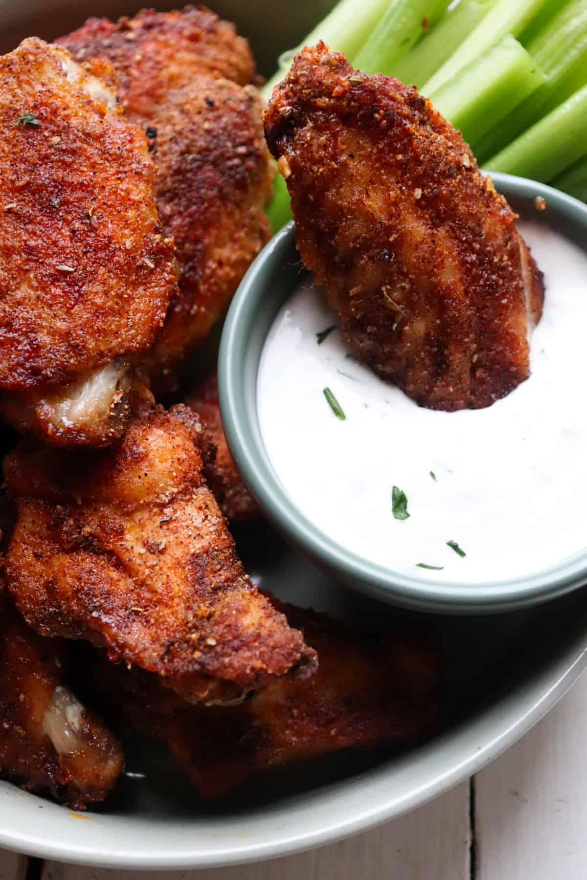 wing dipping in ranch.