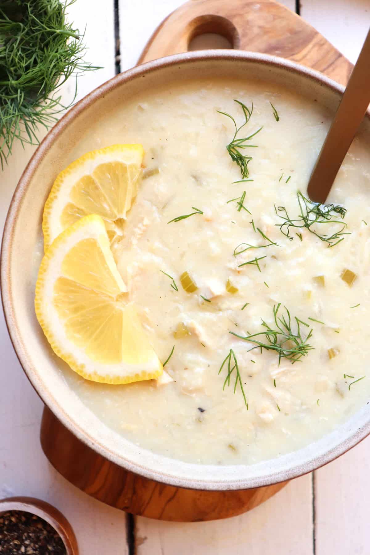 Greek lemon rice soup with lemon and dill garnish.
