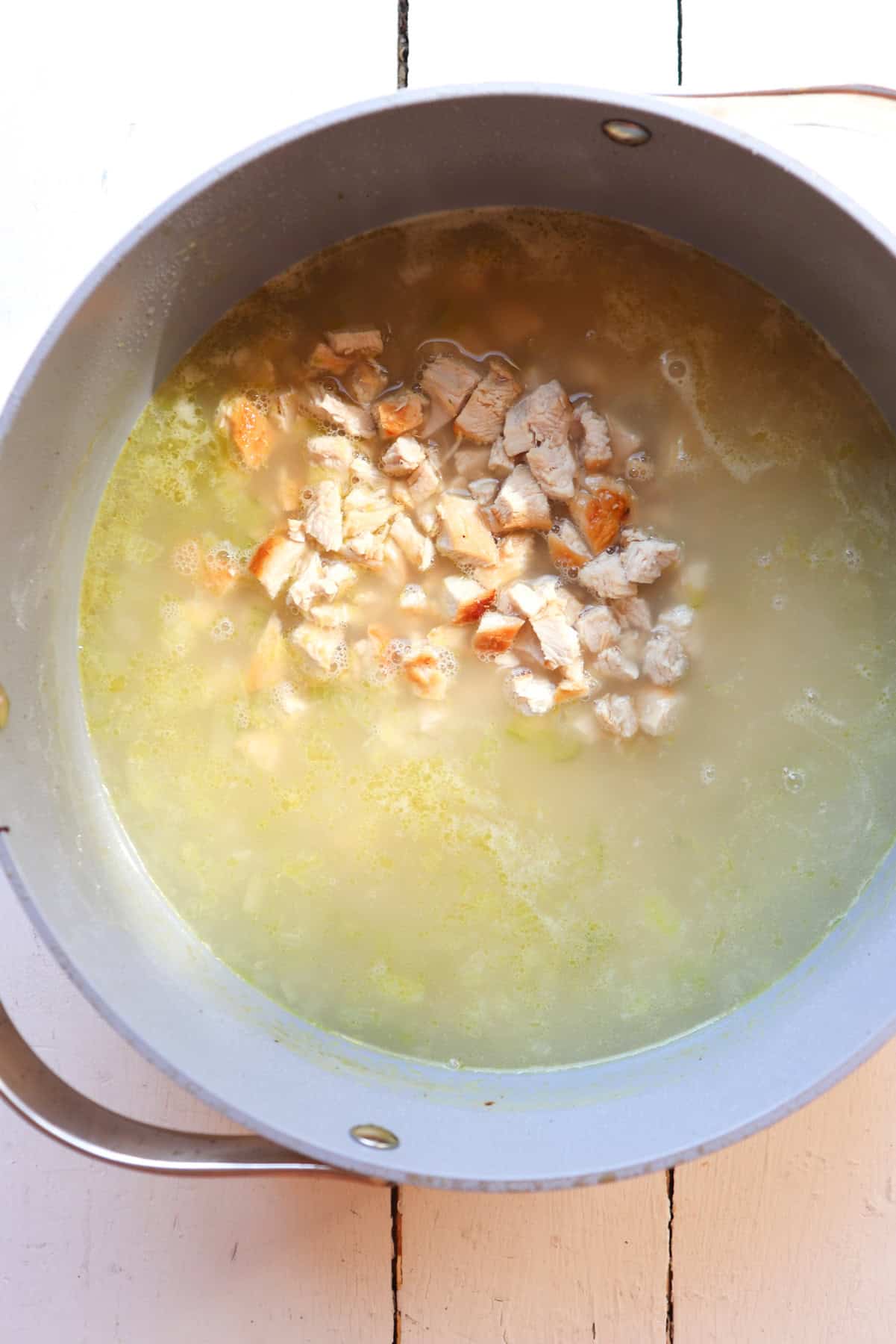 pot of greek lemon rice soup with chicken added.