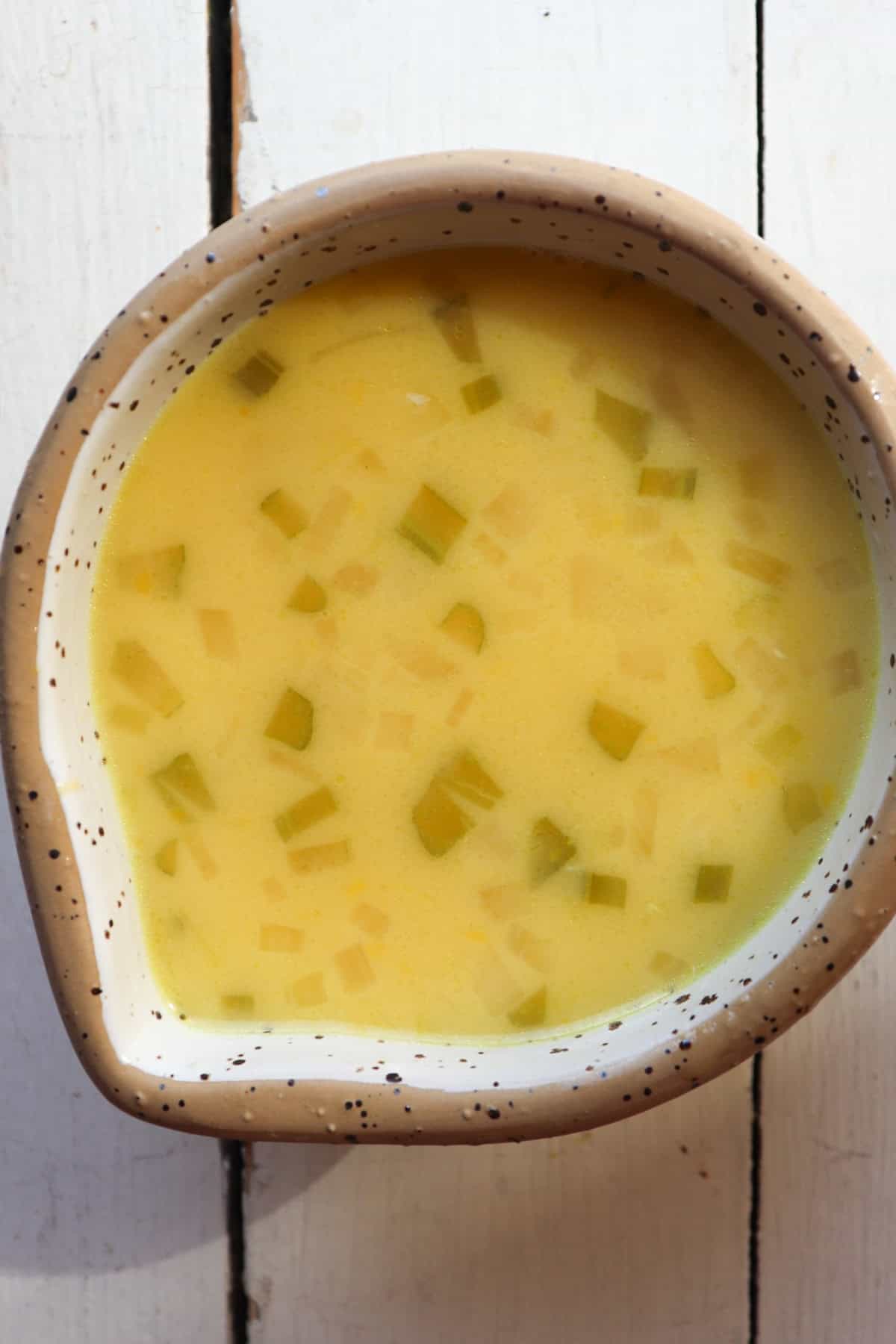 Greek lemon rice soup ingredients in mixing bowl.