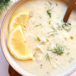 Greek lemon rice soup with lemon and dill garnish.