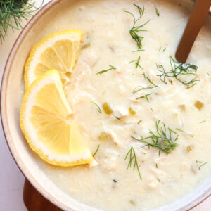 Greek lemon rice soup with lemon and dill garnish.