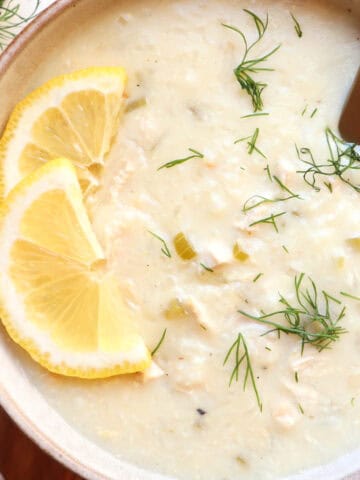 Greek lemon rice soup with lemon and dill garnish.