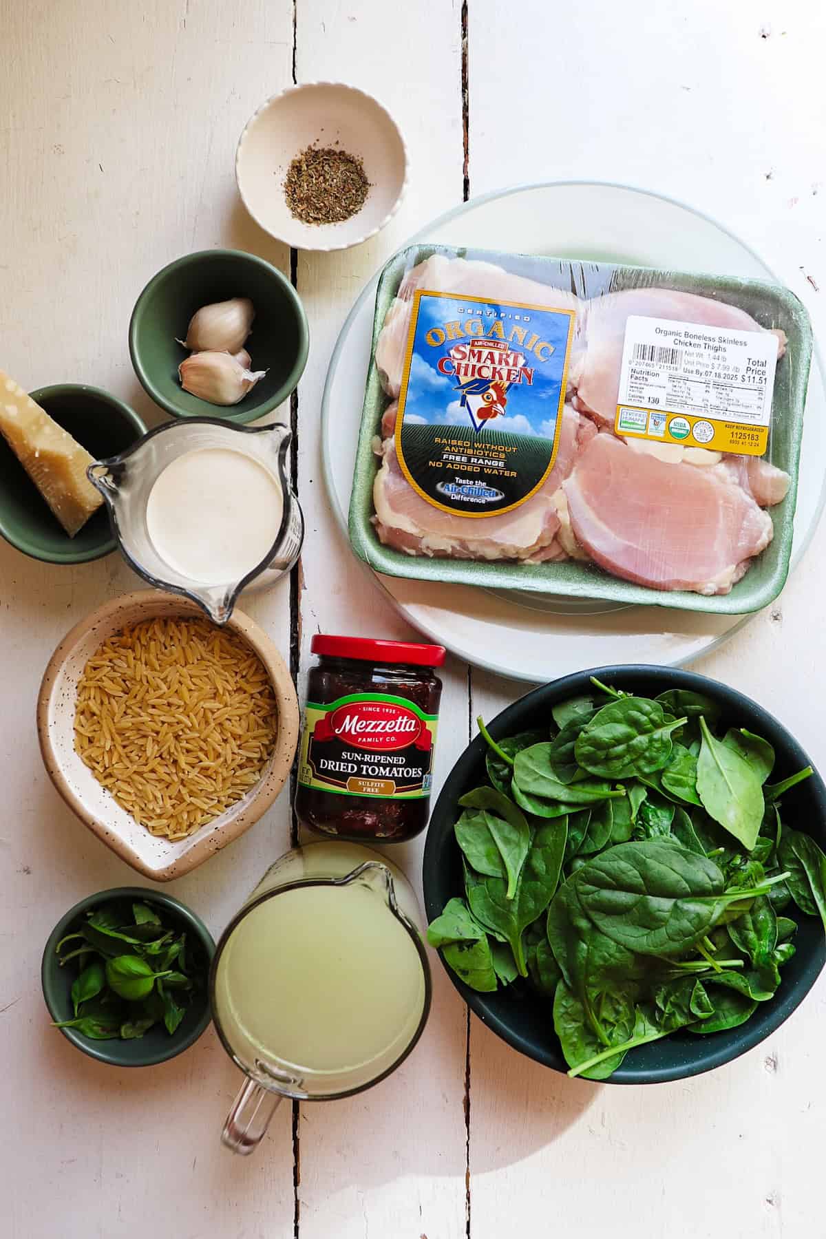 ingredients for marry me chicken orzo on a white table.