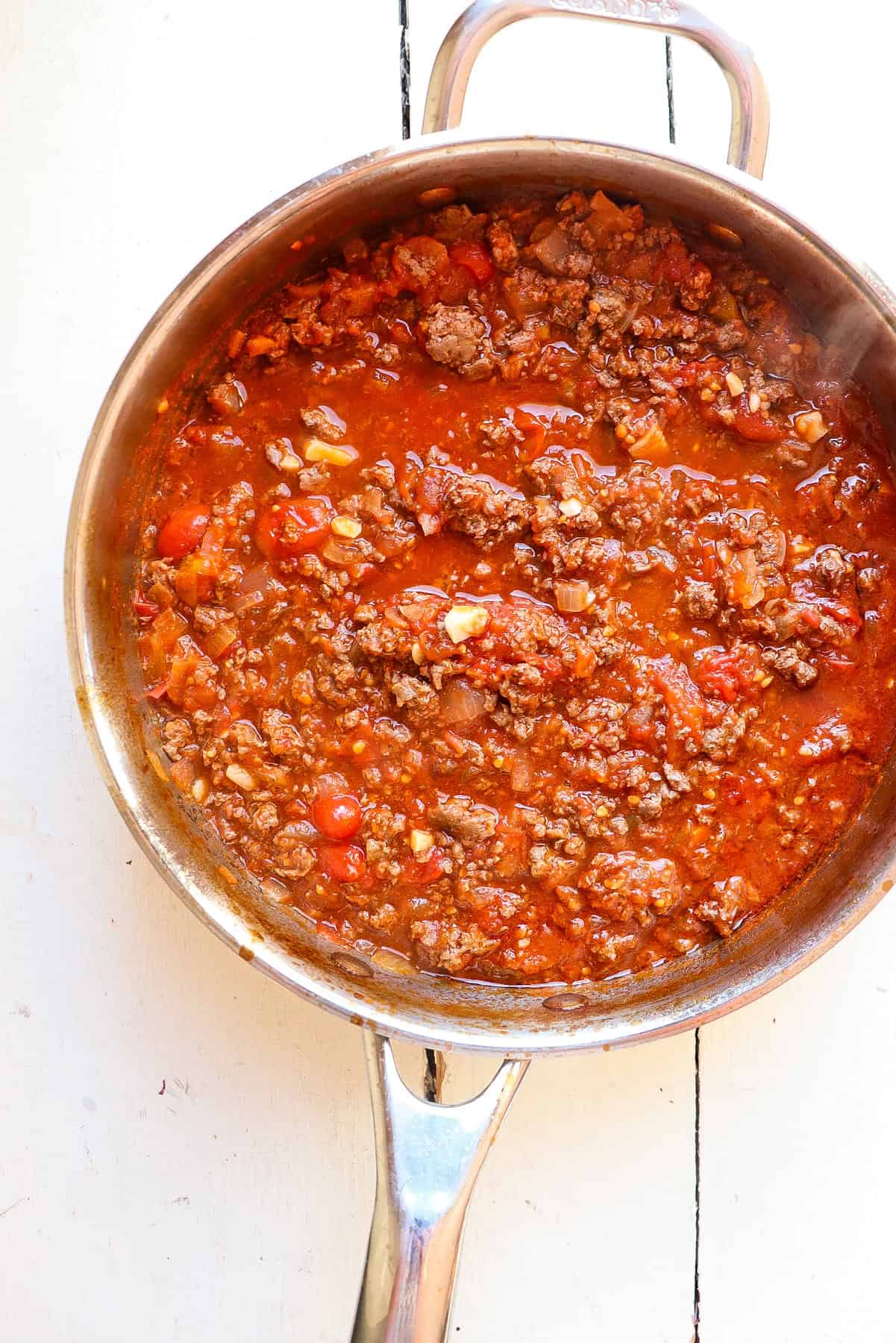 tomato sauce and ground meat in a pan.