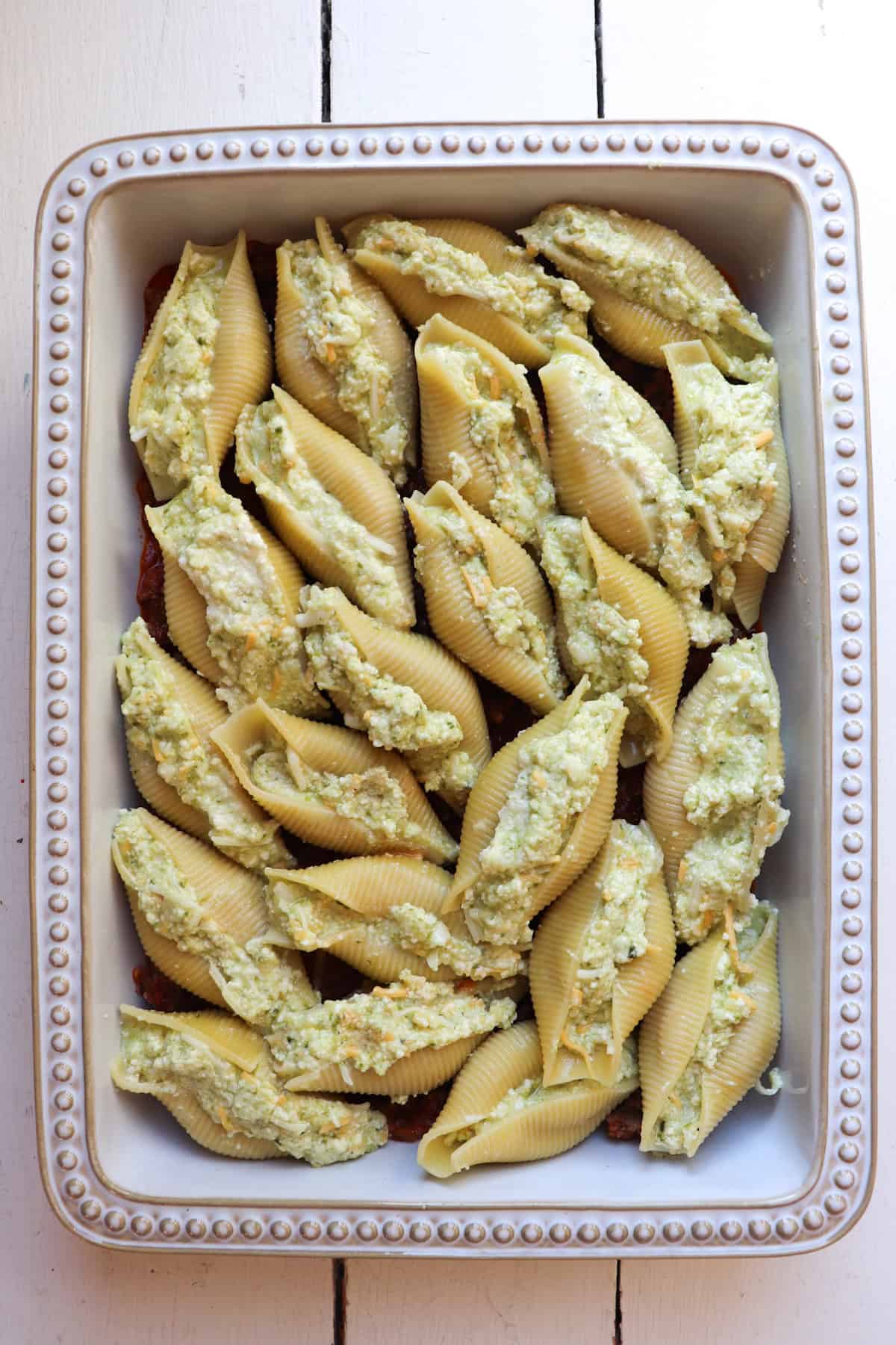 layer of ricotta stuffed shells in cooking pan.