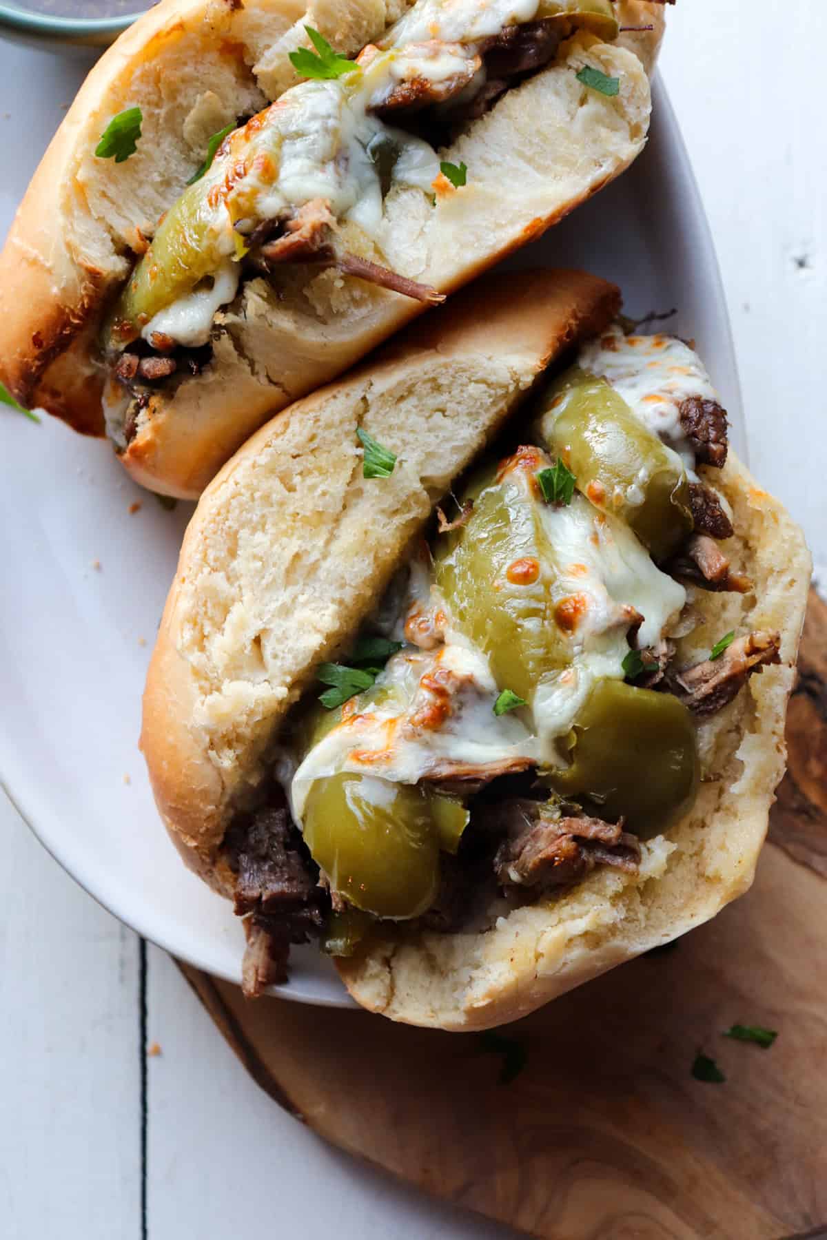 finished slow cooker italian beef sandwich on a wooden board.