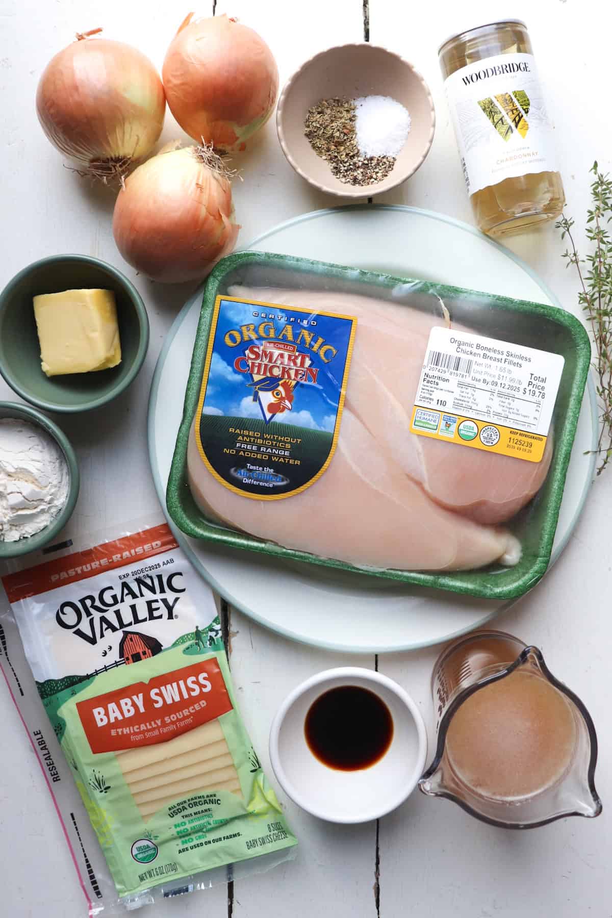 ingredients for french onion soup chicken on a white table. 
