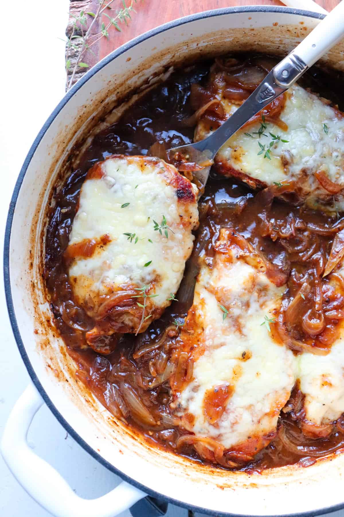 french onion soup chicken in a white skillet.