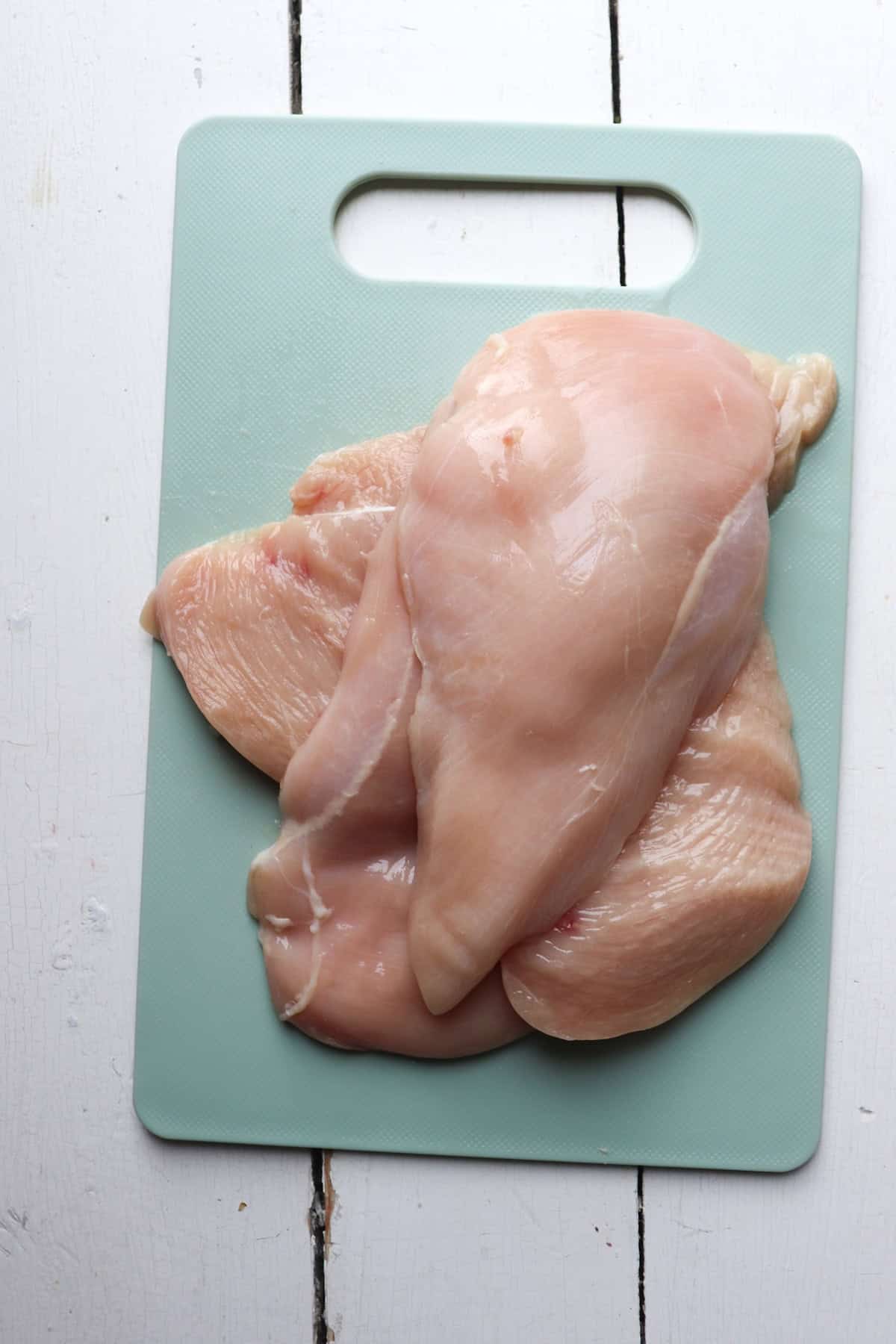 chicken breasts on a cutting board.