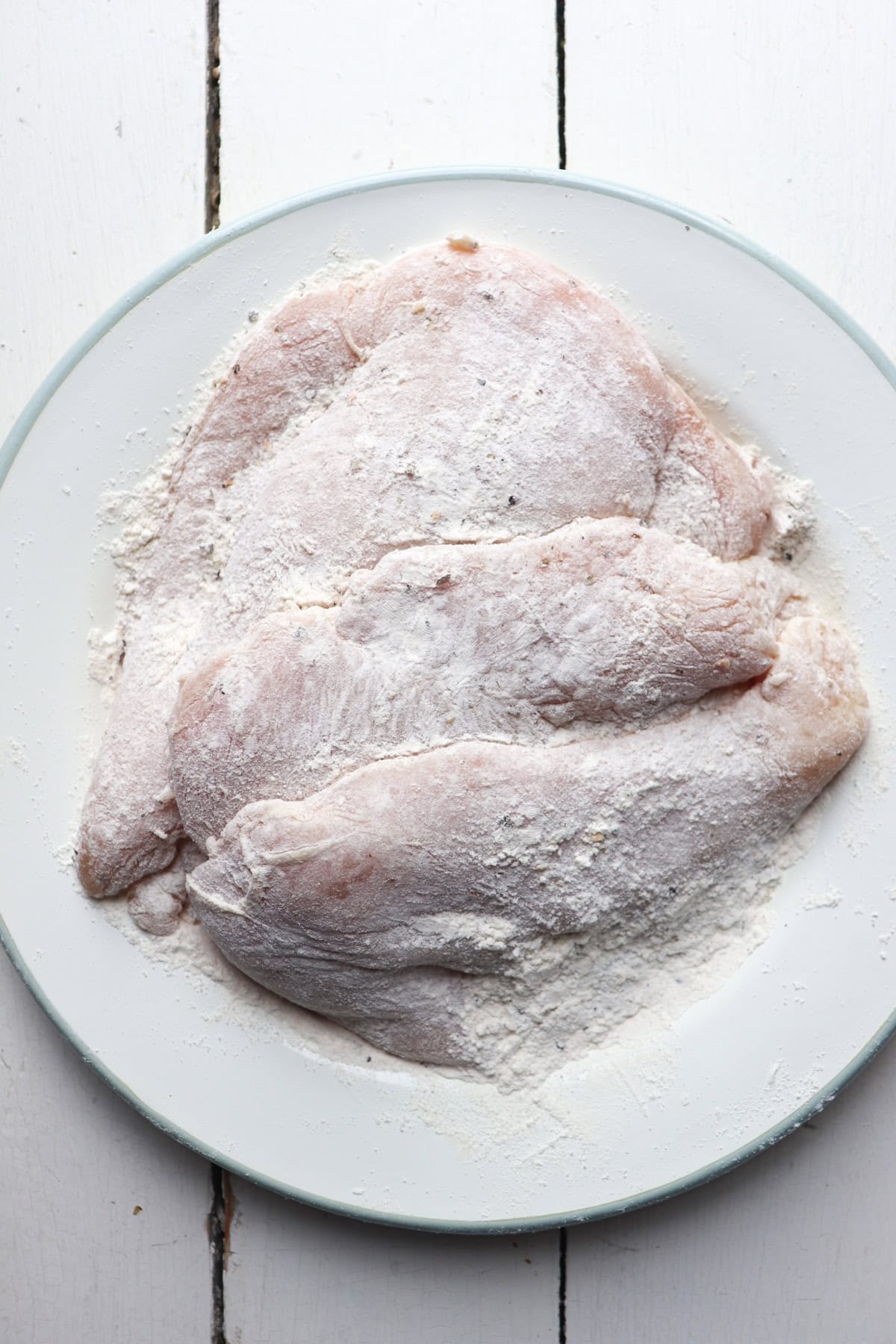 chicken cutlets coated with flour.