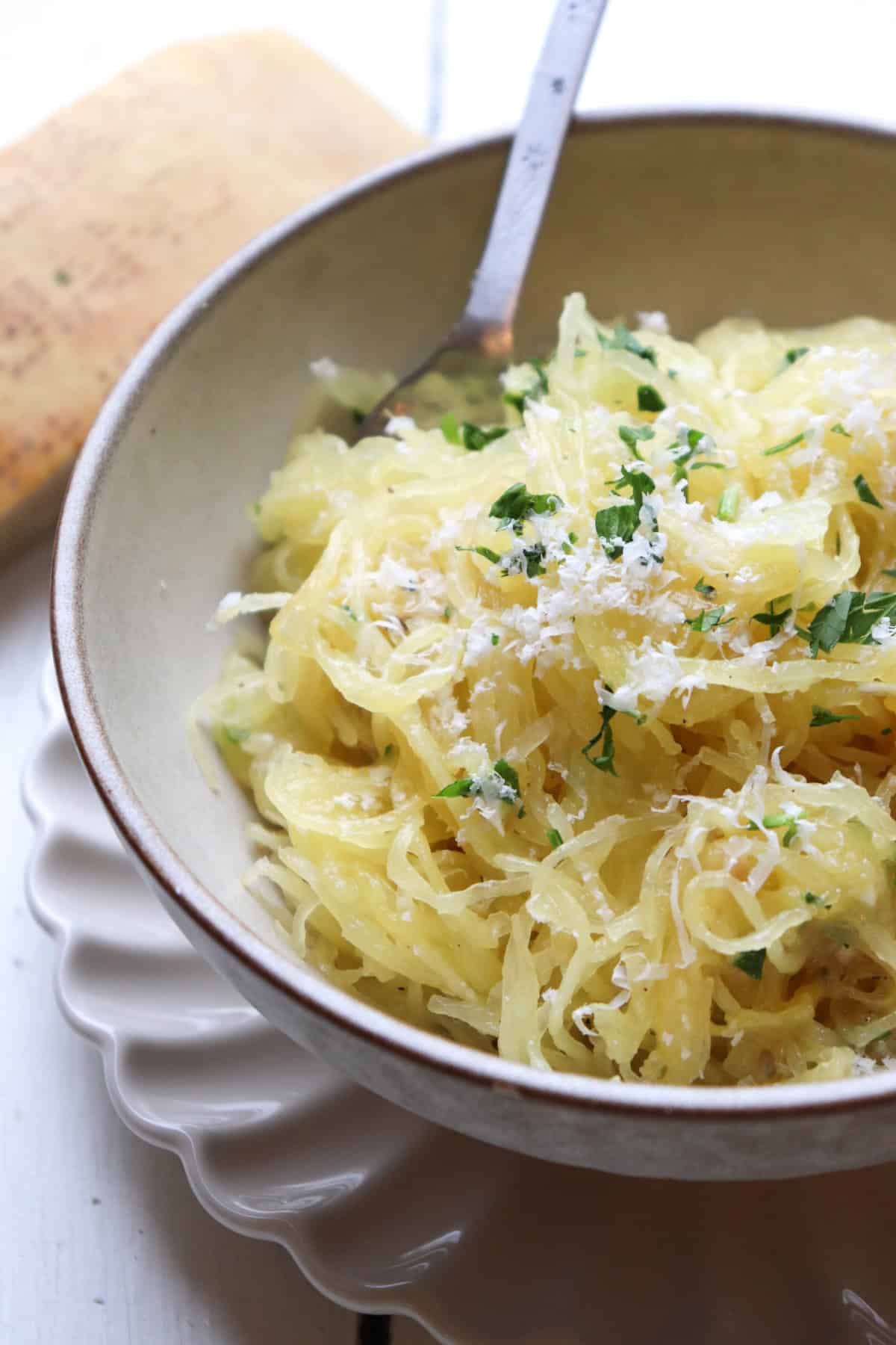 garlic parmesan spaghetti squash on plate with fork.