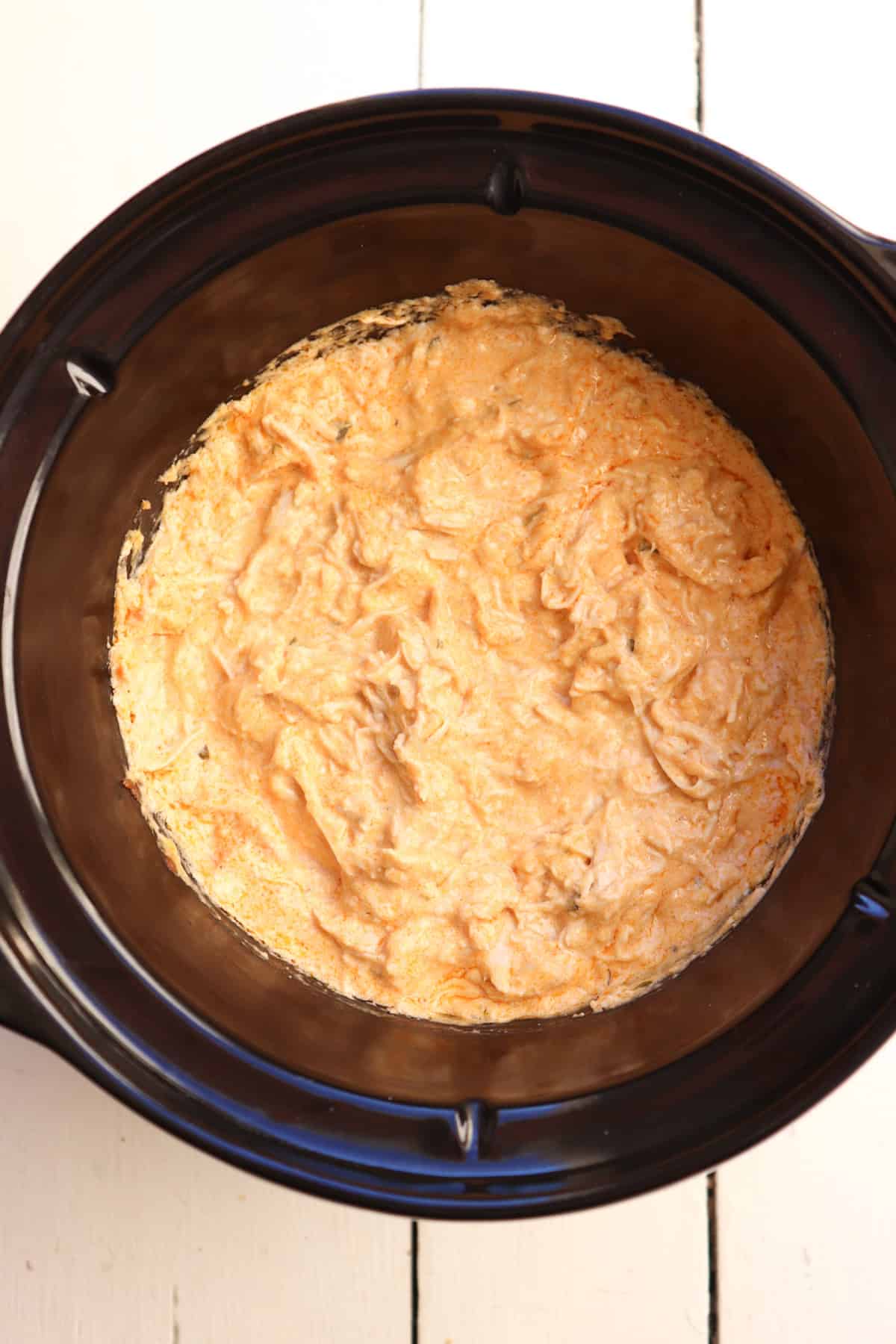 cooked buffalo chicken dip in slow cooker.