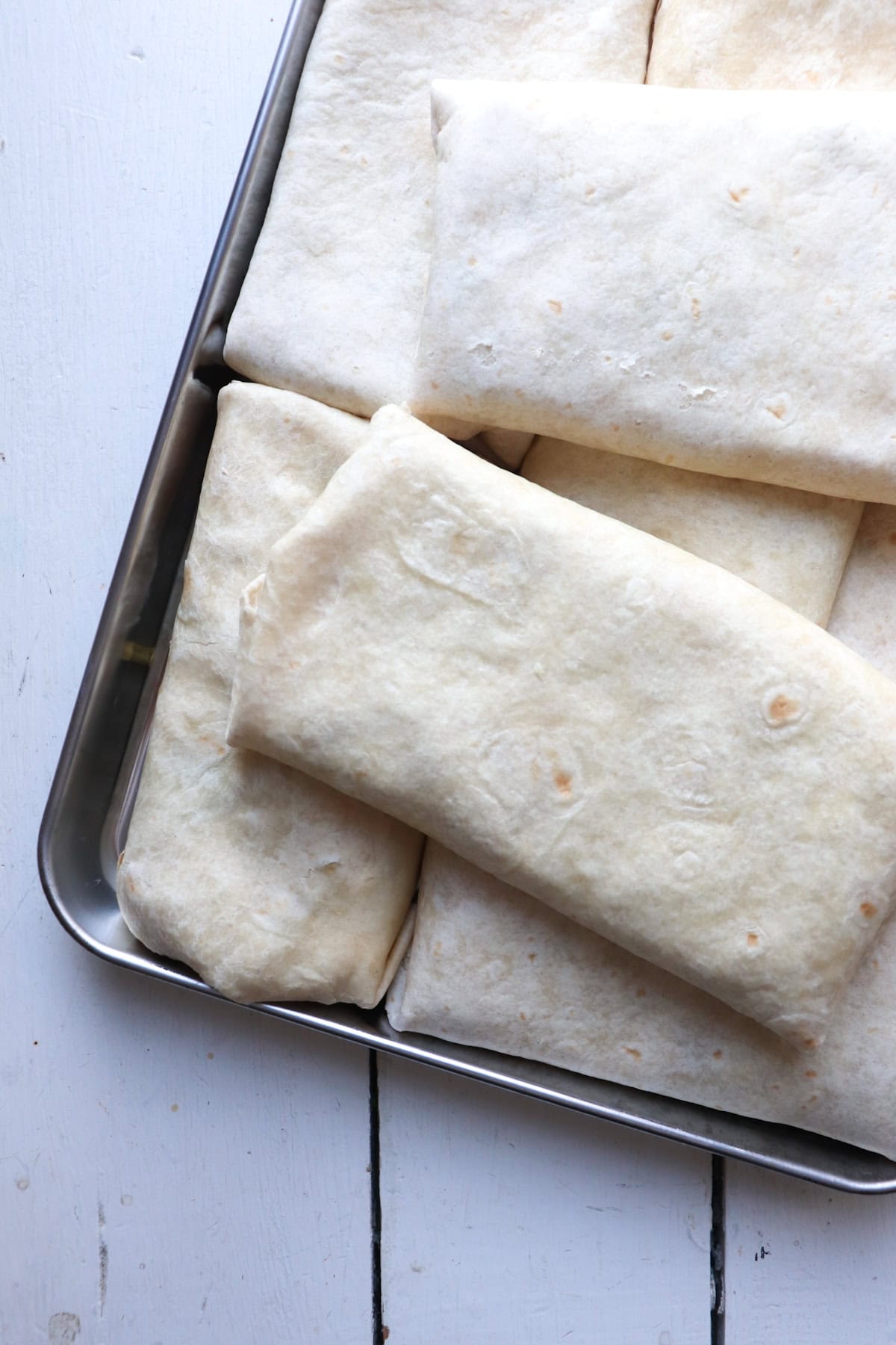 sheet pan breakfast burritos on baking sheet.