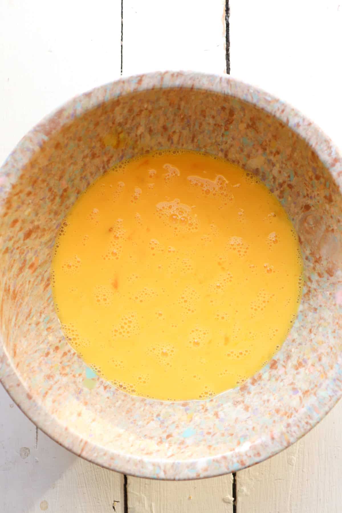 bowl of beaten eggs and milk.