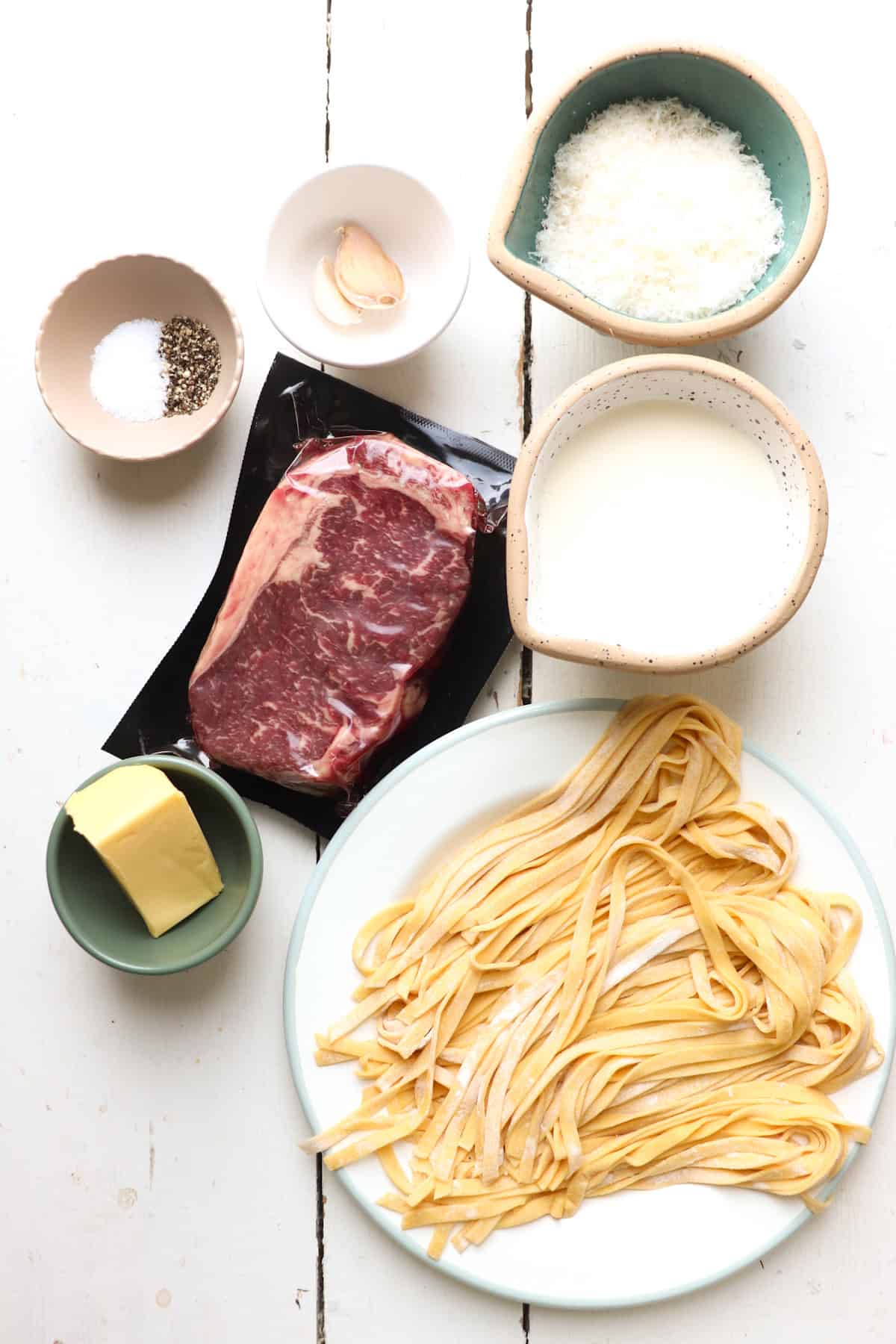 ingredients for steak fettuccine alfredo on table.