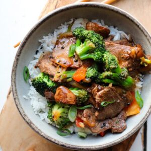 venison stir fry on rice in a bowl featured picture.