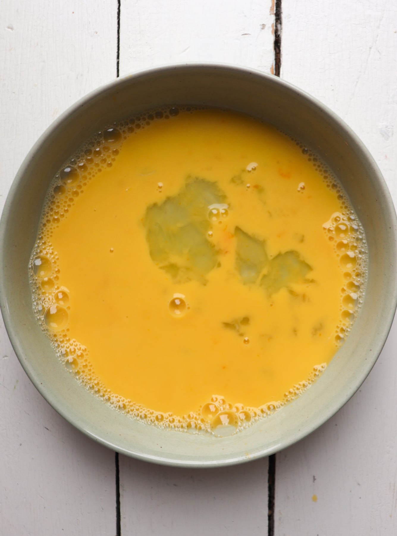 egg wash in a green bowl.