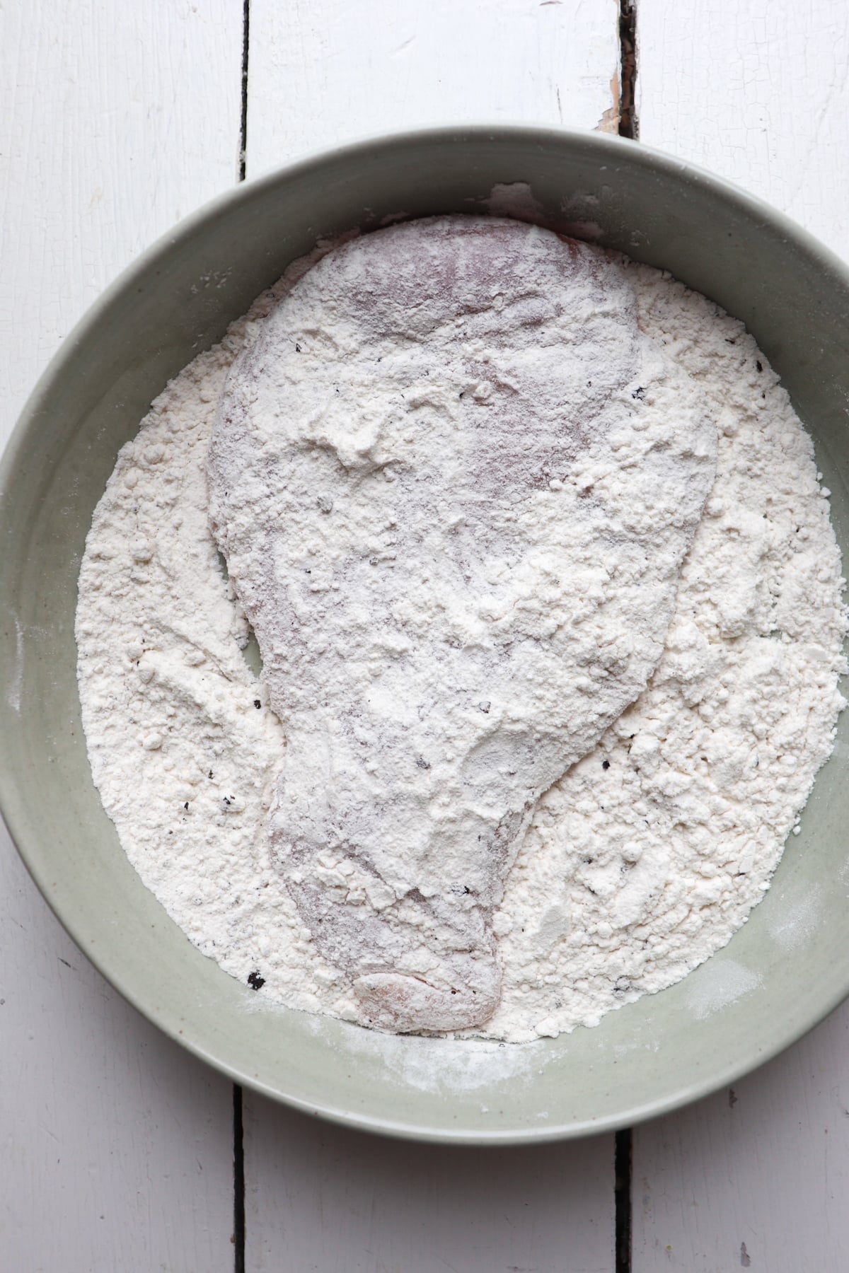 chicken cutlet in flour mixture.