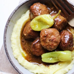 bowl of mississippi meatballs on a bed of mashed potatoes.