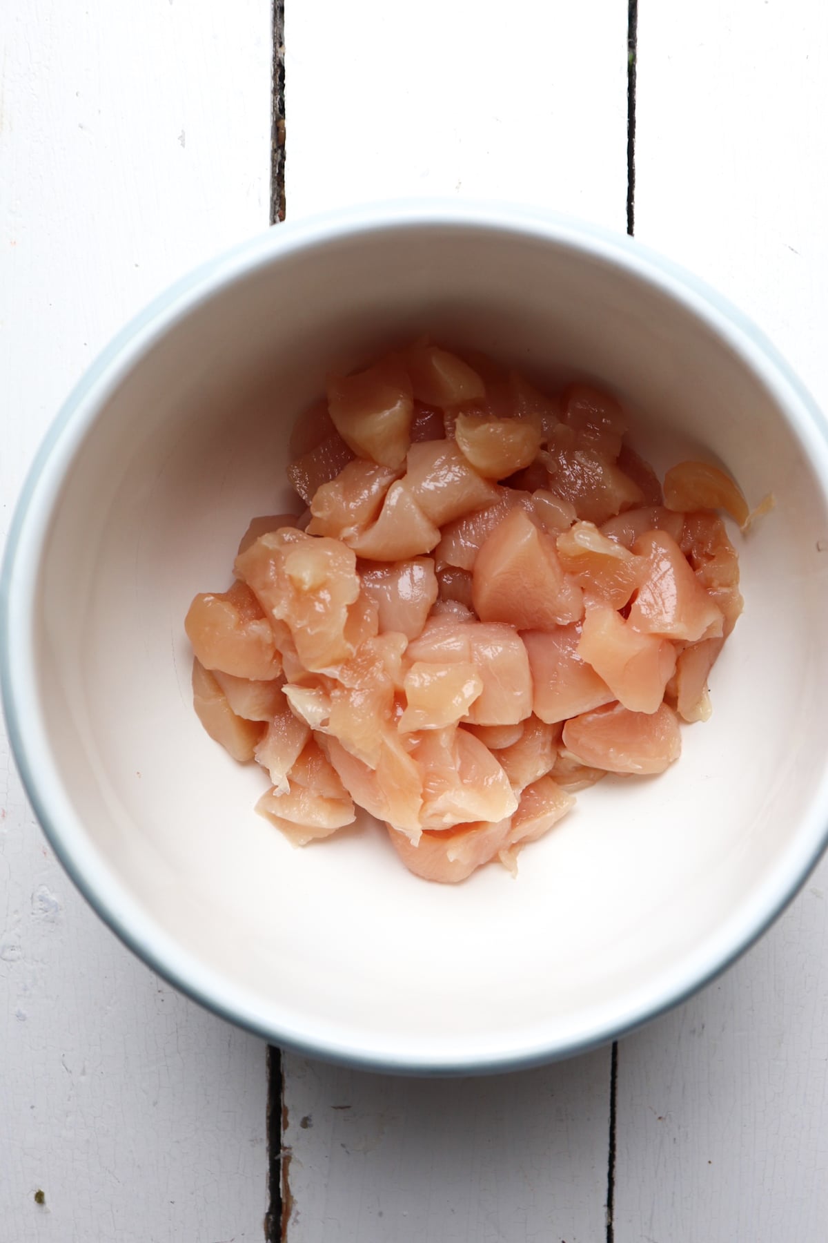 chicken pieces in a white bowl.