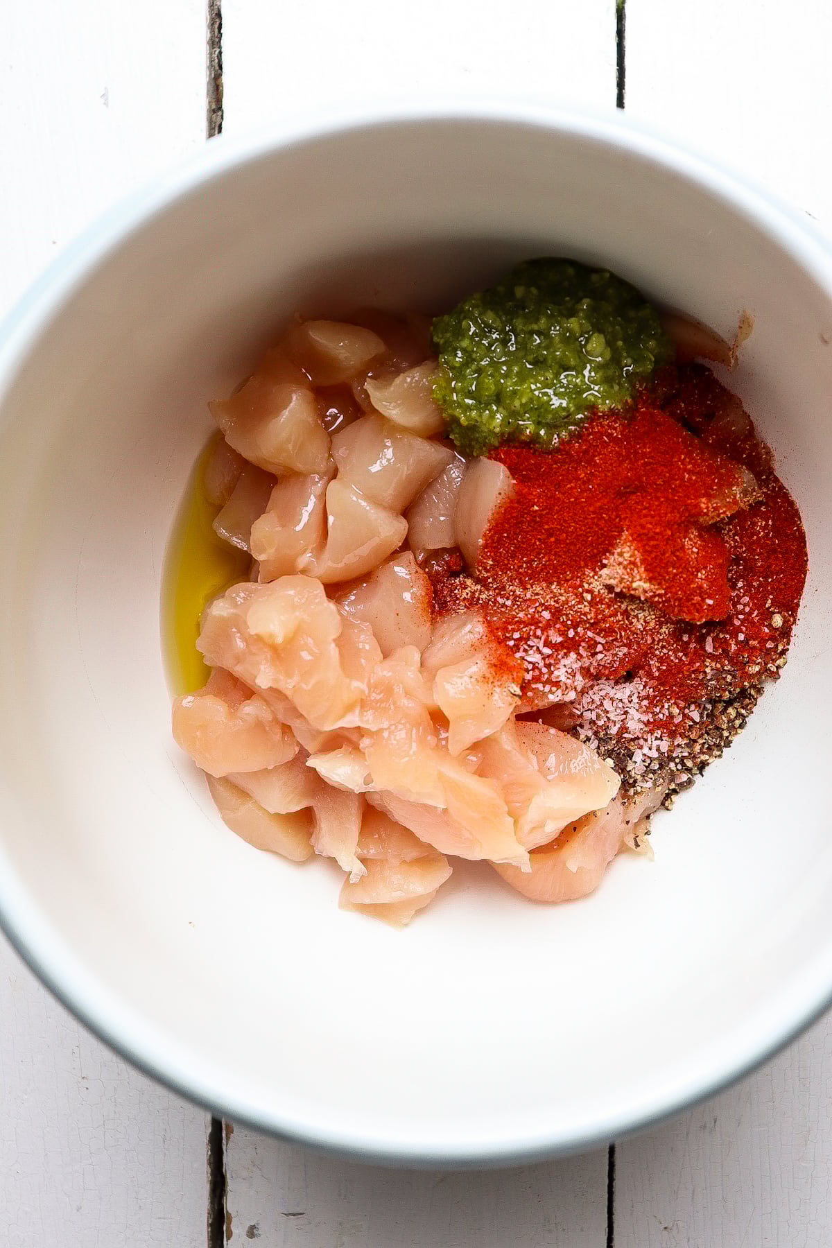seasoning added to cut up chicken pieces.