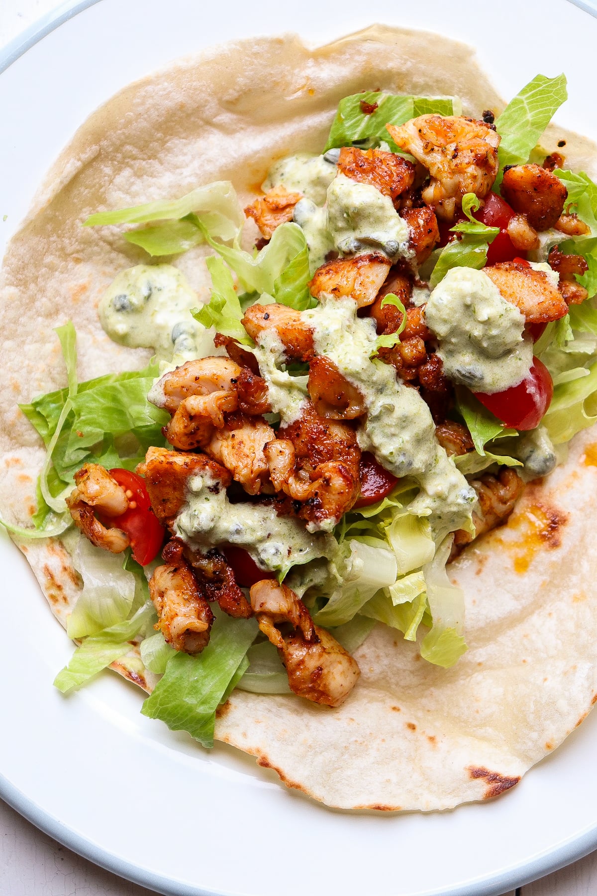 pesto wrap on a plate before it has been wrapped up.