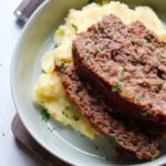 2 slices of venison meatloaf stacked on top of each other.