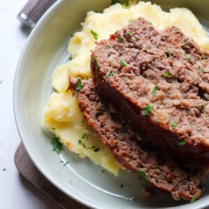 2 slices of venison meatloaf stacked on top of each other.