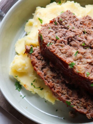 2 slices of venison meatloaf stacked on top of each other.