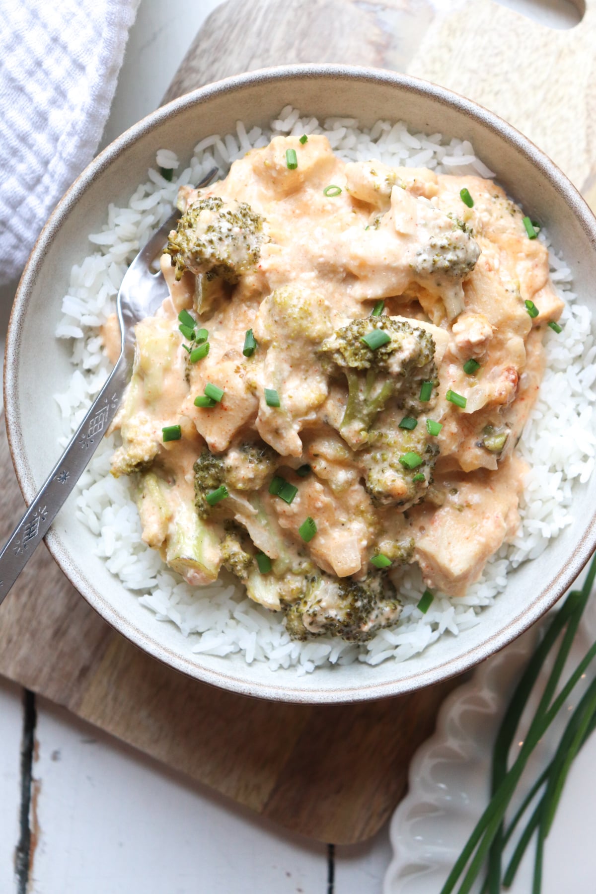 plate of rice on top with crockpot chicken broccoli.
