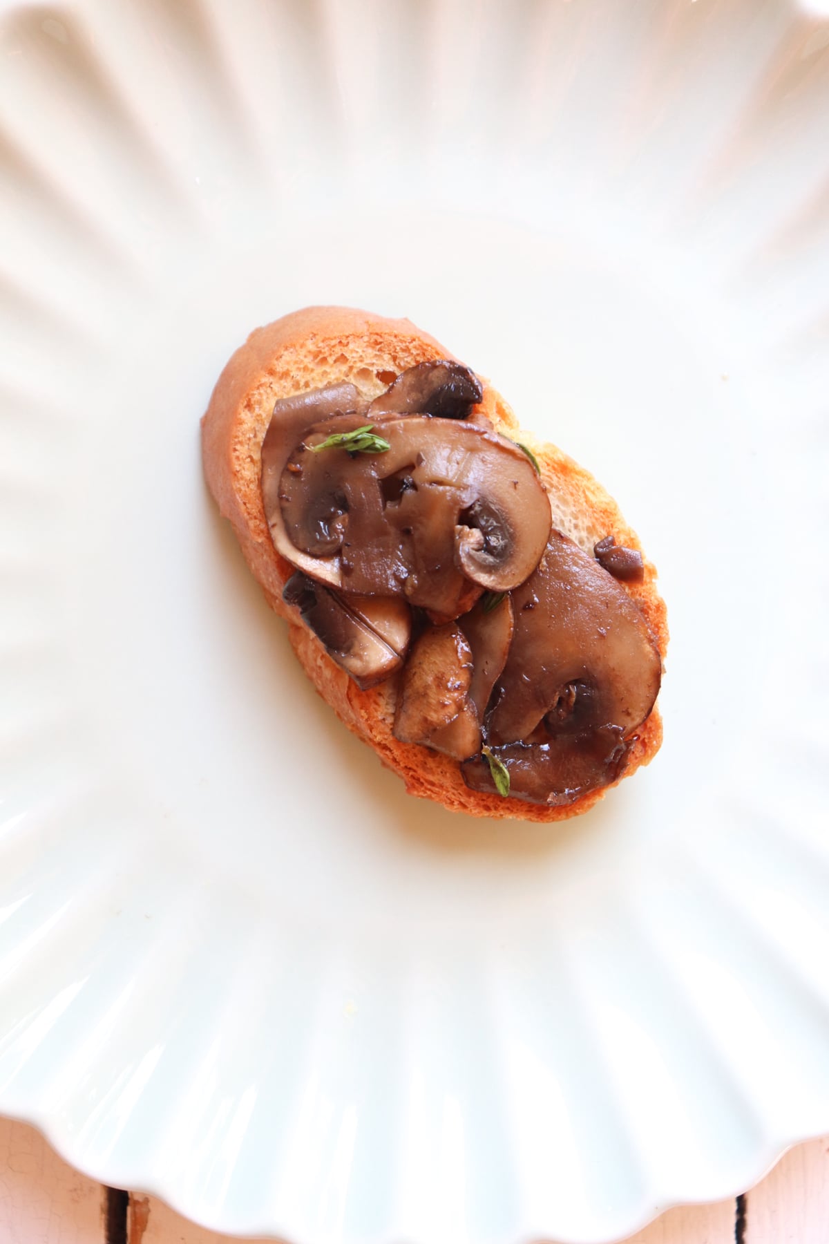 mushroom layer placed on top of crostini bread.