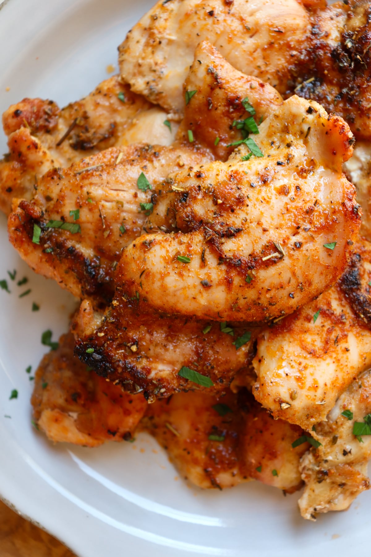 plate of boneless skinless chicken thighs seasoned with a spice blend.