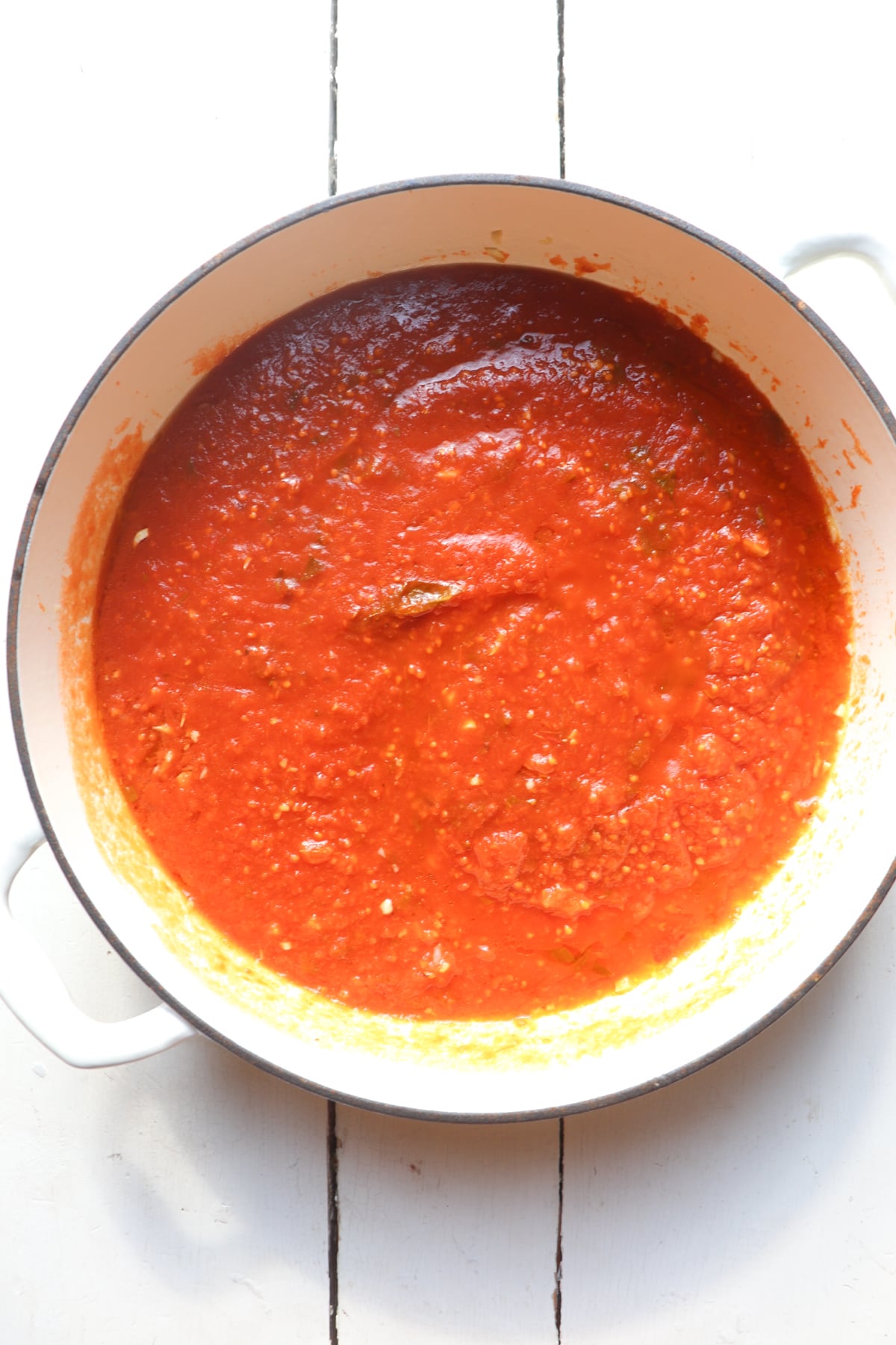 red sauce in a large white skillet.